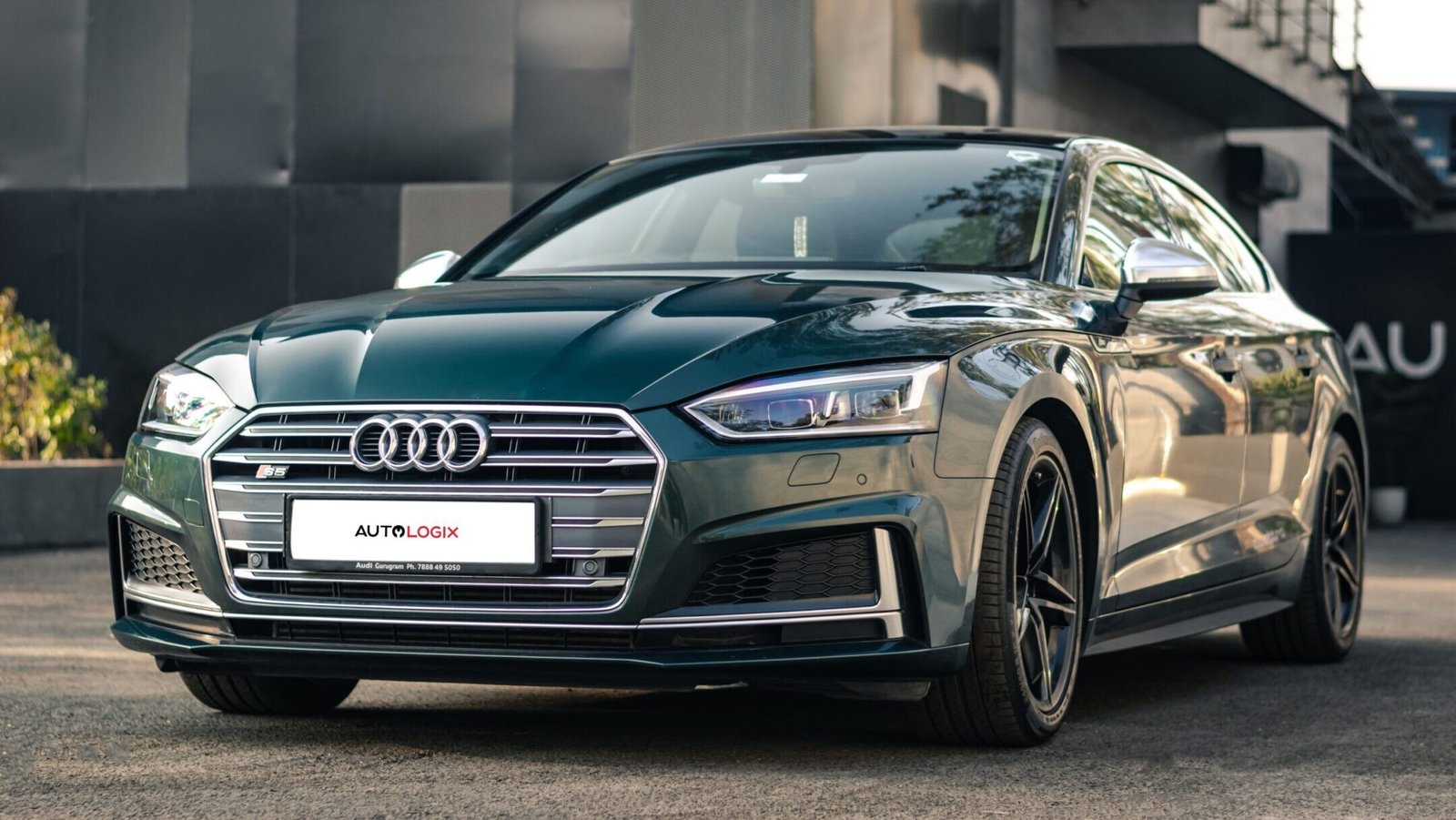 Sleek black Audi S5 sports car parked outdoors showcasing its modern design and luxury features.